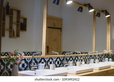 Clean and fresh toilet room with natural light, Moroccan décor and big wall mirror - Powered by Shutterstock