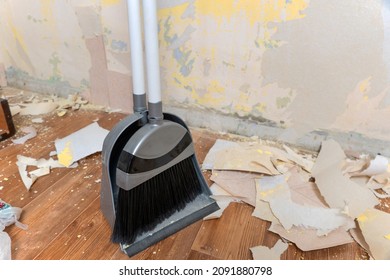 Clean Up Garbage After Repairs.Sweep Up Construction Debris With A Brush In A Dustpan.Sweeping At Home.Tools For Cleaning The House.Make Home Repairs.The Dust And Debris After The Renovation.Handyman