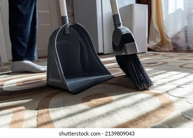 Clean up the garbage from the floor with a broom for cleanliness. Sweep away dust and dirt with a brush into a dustpan.