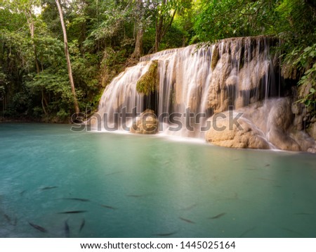 Clean green emerald water from the waterfall Surrounded by small trees - large trees,  green colour,  fish live in the pond, Erawan waterfall, Kanchanaburi province, Thailand
