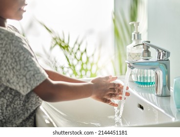 Clean Hands Are Guardians Of Health Especially For Kids. Closeup Shot Of An Unrecognisable Boy Washing His Hands At A Tap In A Bathroom At Home.