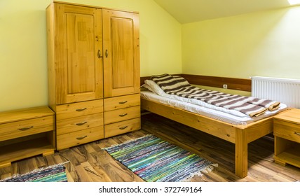 Clean Hostel Room With Bed And Wardrobe