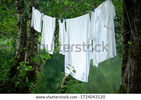 Clean linen is dried in the fresh air. Soap removes any dirt. A white sheet like a blank sheet of paper.
