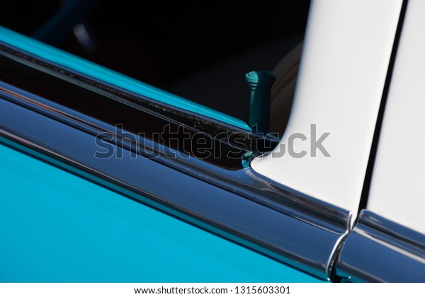 The clean lines and bright colors of this\
turquoise and white 50s car create an interesting minimalist\
abstract composition.