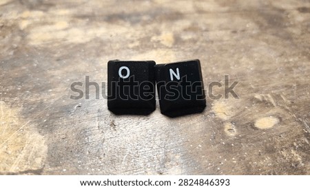 A clean macro view capturing a sequence of mechanical computer keys neatly lined up on a weathered wooden board. The sharp optics highlight the fine plastic texture and standard labeling against the natural background. Perfect for hardware reviews, coding tutorials, and desktop workspace inspiration blogs. The subtle shadows add depth and realism to the composition. This reliable visual asset supports tech enthusiasts and graphic designers seeking authentic computer hardware imagery for digital media projects focused on office organization, productivity tools, and custom mechanical keyboard assembly guides worldwide. 