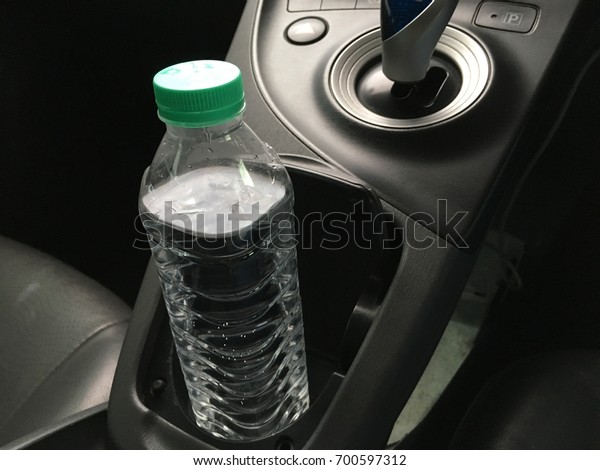Clean mineral water bottle in the car dashboard\
cup holder
