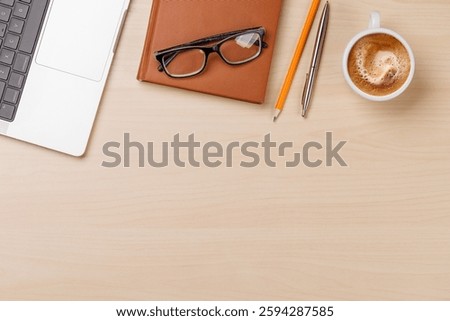 A clean and minimal desk setup featuring a laptop and a coffee cup, providing a perfect workspace with ample copy space for design or text