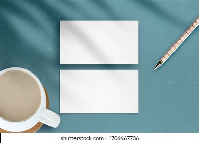 Clean Minimal White Business Card Mockup With Pencil And Cup On Green Blue Color Background.