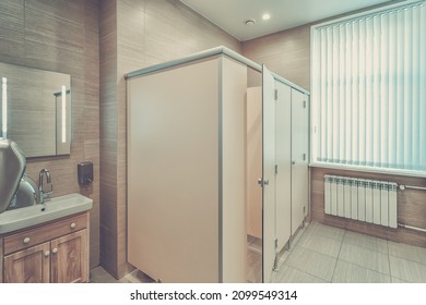 Clean New Public Toilet Room Empty. Public Toilet And Bathroom Interior With Wash Basin And Toilet Room.