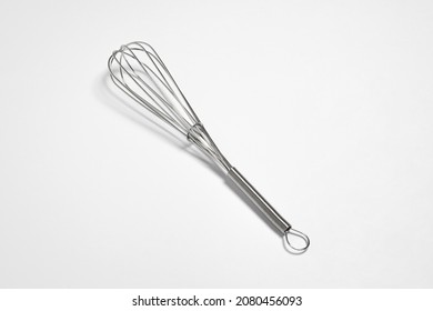 Clean New Steel Whisk Isolated On White Background. Cooking Egg Beater Mixer Whisker With Plastic Handle.High Resolution Photo. Mock Up