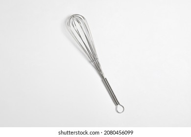 Clean New Steel Whisk Isolated On White Background. Cooking Egg Beater Mixer Whisker With Plastic Handle.High Resolution Photo. Mock Up