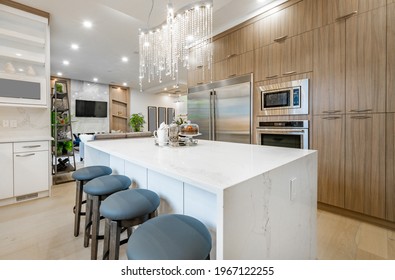 Clean new white kitchen with crystal chandelier