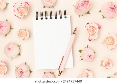 Clean notepad mockup. Stationery and pink rose flowers on a beige background. - Powered by Shutterstock