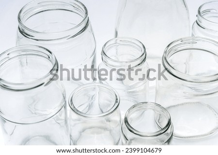 Clean open empty glass jar close up view on white background