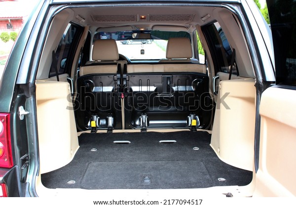 Clean,\
open empty trunk in the car. Open back door modern car. Car boot is\
open. Modern wagon car open trunk. Front\
view.