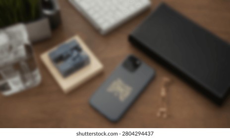 A clean and organized desk setup featuring a smartphone, wireless keyboard, and a black notebook, perfect for a modern workspace.
