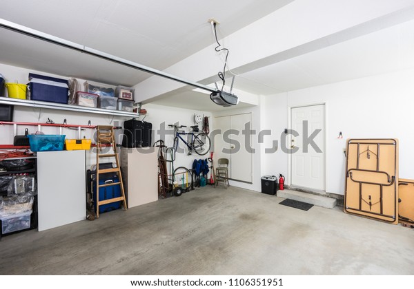 Clean organized suburban\
residential two car garage with tools, file cabinets and sports\
equipment.  