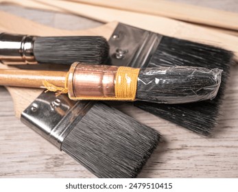 Clean paint brushes on a wooden floor. Close up.
 - Powered by Shutterstock