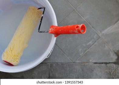 Clean paint roll in white plastic bucket after complete job, house improvement concept. - Powered by Shutterstock