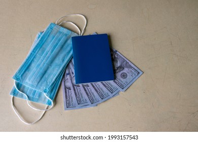 A Clean Passport Crust On A Background Of US Dollars And A Medical Mask.