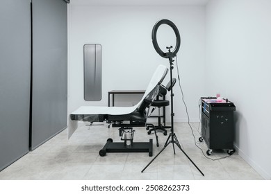 Clean and professional microblading studio setup with a work chair and lighting equipment