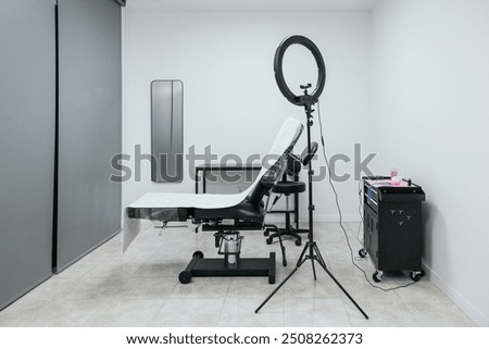 Clean and professional microblading studio setup with a work chair and lighting equipment