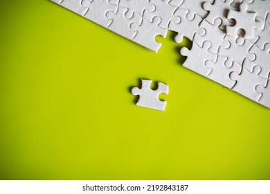 Clean puzzle elements on the background. Empty puzzle piece on table. Teamwork concept.
