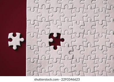 Clean puzzle elements on the background. Empty puzzle piece on table. Teamwork concept.