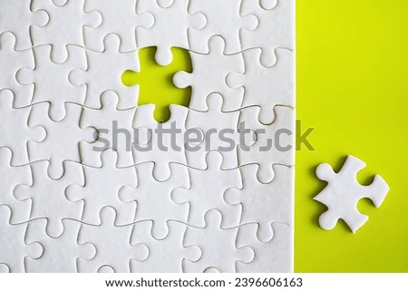 Clean puzzle elements on the background. Empty puzzle piece on table. Teamwork concept.