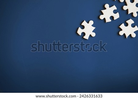 Clean puzzle elements on the background. Empty puzzle piece on table. Teamwork concept.