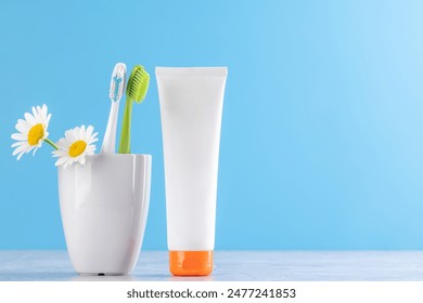 A clean and refreshing image featuring toothpaste and toothbrushes, promoting oral hygiene and a bright smile