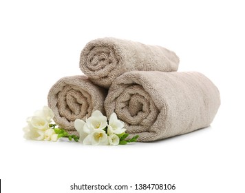 Clean rolled towels with flowers on white background - Powered by Shutterstock