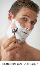 Clean Shaven Is Best. A Handsome Young Man Shaving.