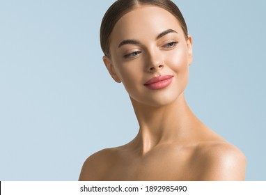 Clean skin beauty woman face healthy skin natural make up tanned female over blue background