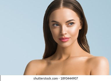 Clean skin beauty woman face healthy skin natural make up tanned female over blue background
