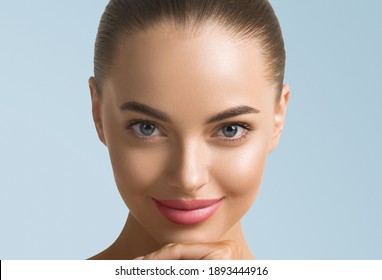 Clean Skin Woman Face Close Up Skin Beauty Tanned Face Beautiful Smile Over Blue Background