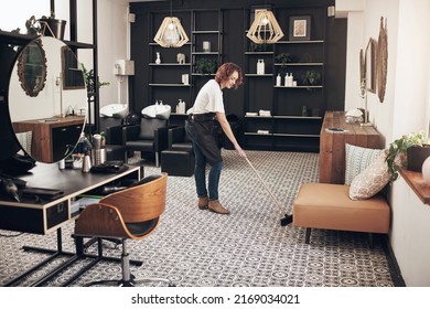 A clean space is a happy space. Shot of a hairstylist sweeping the salon. - Powered by Shutterstock