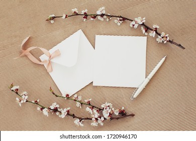 A Clean Square Envelope And Card Decorated With Cherry Blossoms In Delicate Chocolate Colors