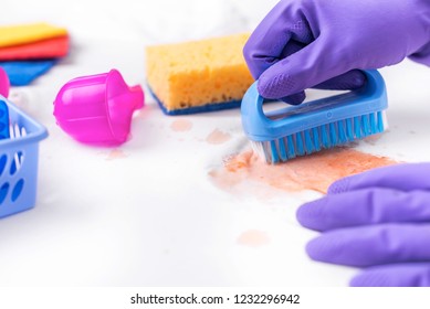 Clean the stain on clothes with a special brush. Well visible texture of the contaminated tissue.
