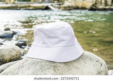 With its clean and stylish design, this white bucket hat provides the perfect accessory for a day spent near the river, white blank bucket hat mockup image