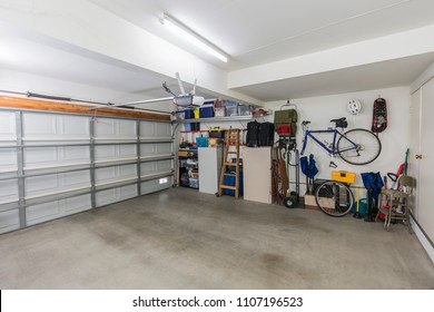 Clean suburban two car garage interior with tools, file cabinets and sports equipment.  