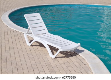 Clean Swimming Pool And Empty Resting Chair