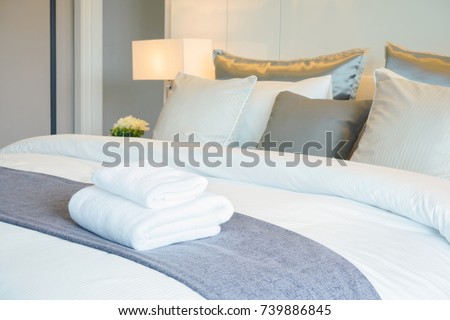 Clean towel on bed in modern interior bedroom