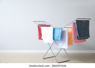 Clean towels hanging on dryer indoors
