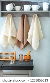 Clean towels with tableware in kitchen