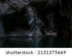 clean underground cave river in steep stone banks in the dark