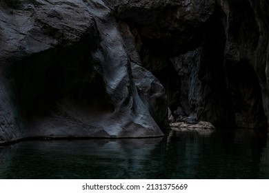 clean underground cave river in steep stone banks in the dark - Shutterstock ID 2131375669