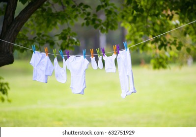 Clean Washed Children Clothes Are Drying On A Rope In The Street At Fresh Air Sunny Summer Day