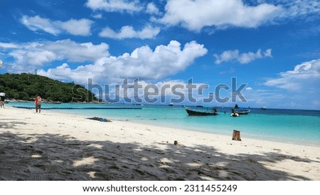Clean white beach and turquoise clear blue seaside seacoast on the natural sunny day with a clear blue sky and  white fluffy cloudscape 