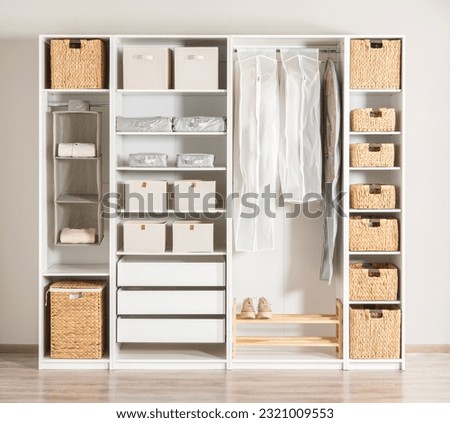 a clean and white closet with multiple drawers and shelves, providing plenty of storage space Stock photo © 